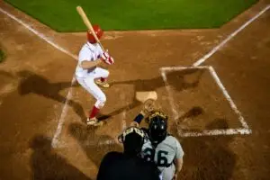 Baseball player locked in at the plate preparing to swing, showing focus and confidence.